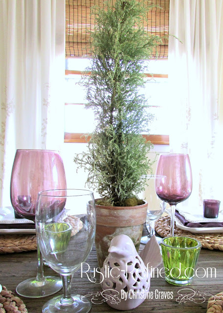 Table setting using white dishes and purple and green colors as accents