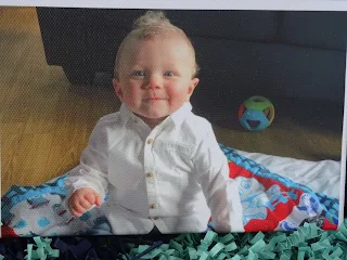 cute little doy smiling at camera in white shirt 