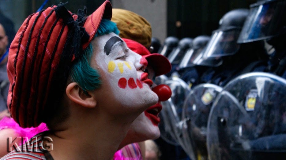 35 moments of violence that brought out incredible human compassion - protesters dressed as clowns entertain guards at a g20 meeting