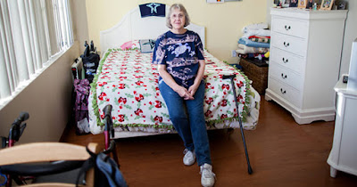 Woman sitting in house provided by housing grant