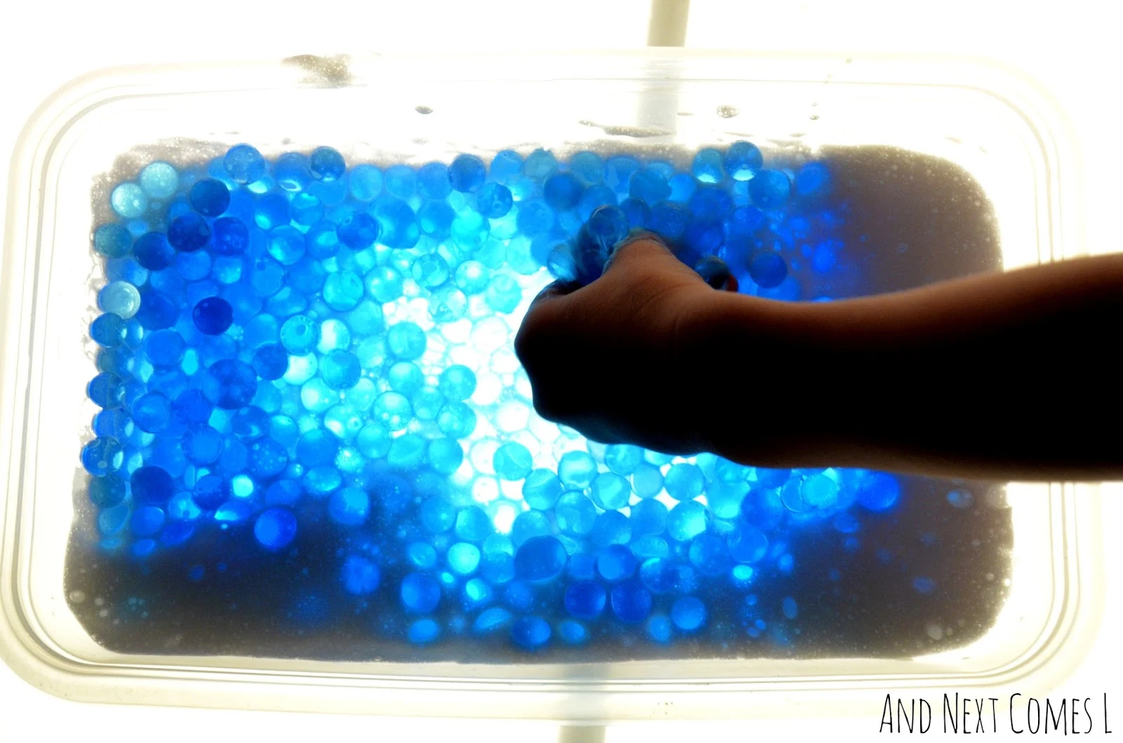 Water beads and soap foam on the light table from And Next Comes L