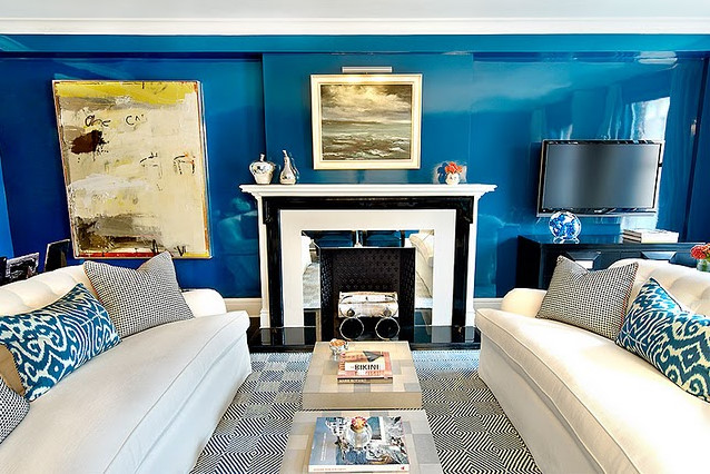 glossy blue walls blue ikat pillows white sofa