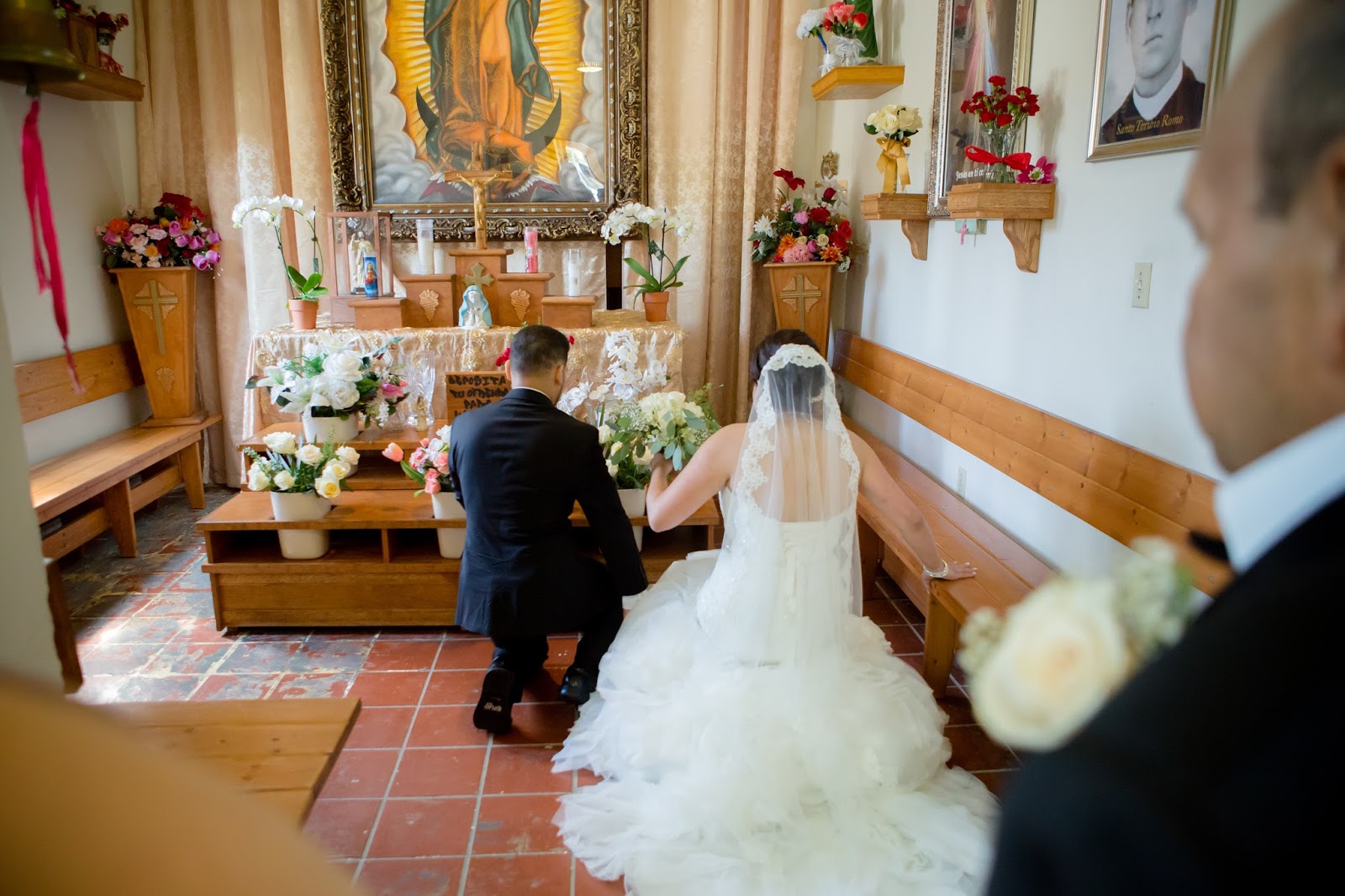 Bride and Groom present flowers to La Virgen de Guadalupe Altar