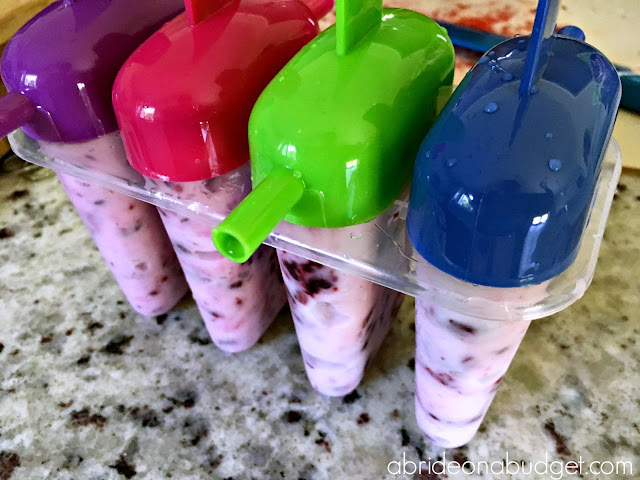 Reusable ice pop mold filled with yogurt bark.