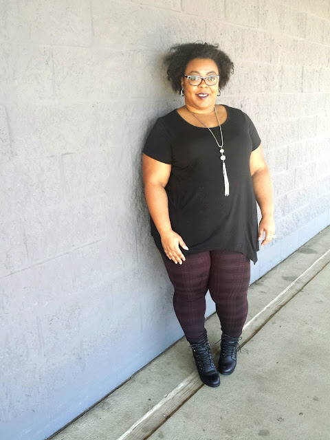 plus size gothic inspired, black tunic, printed leggings, thick thighs, stacked combat booties, natural afro, long tassel necklace, trendy, thrifty shopper
