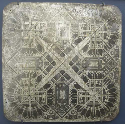 Square silver board with decorative pattern kind of like an ornate parcheesi board