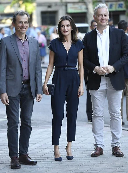 Queen Letizia wore Mango a blue zip-detail jumpsuit, Carolina Herrera navy pumps. diamond leaf earrings at famelab