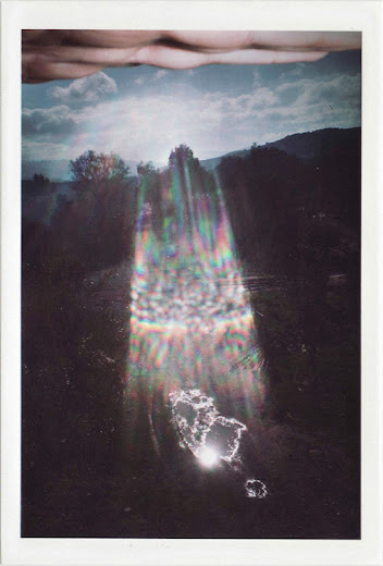 dirty photos - time - cretan landscape photo of lens flare and hand