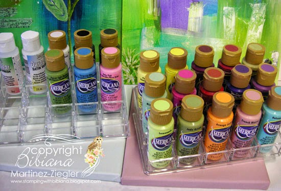 two acrylic stadium organizers for paint bottles