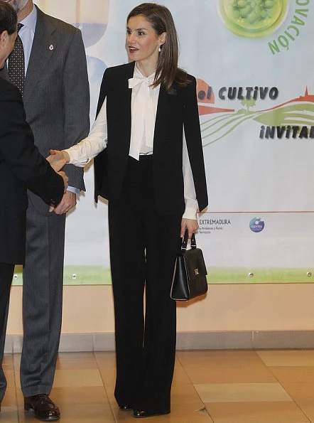 Queen Letizia wore ZARA Cape Jacket, Hugo Boss boots, BOSS Bespoke Bag, Tous earrings