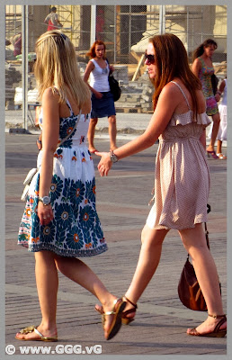 Girls in colorful summer dresses on the street