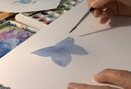 Teknik melukis dengan warna air dengan aplikasi cat yang tipis, yang disebut teknik
