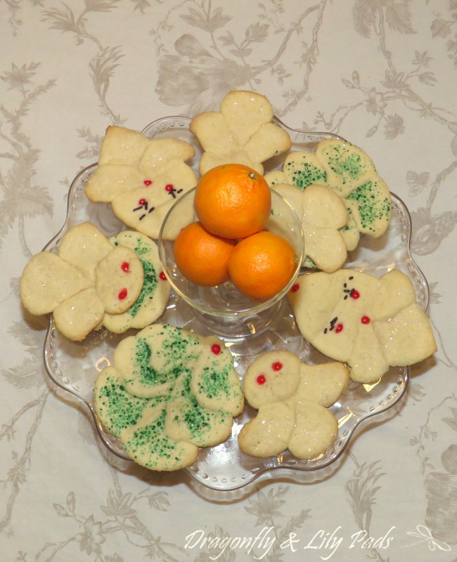 Sugar Cookies made with Pillsbury Sugar Cookie Refrigerated Dough Baked on a Glass Platter with Halo Oranges in the Center.