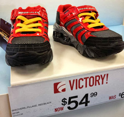 Shiny red kids' running shoes with yellow laces, black soles