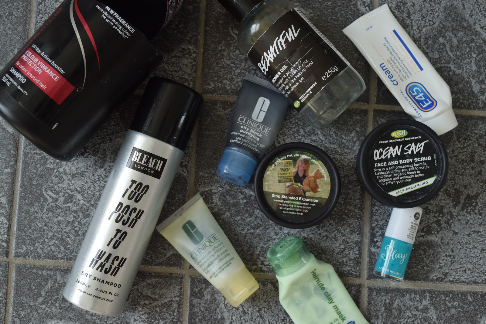 Flatlay of empty beauty products including Lush, Clinique, Tresemmé and Bleach London