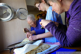 three generations of women making lefse in the kitchen together