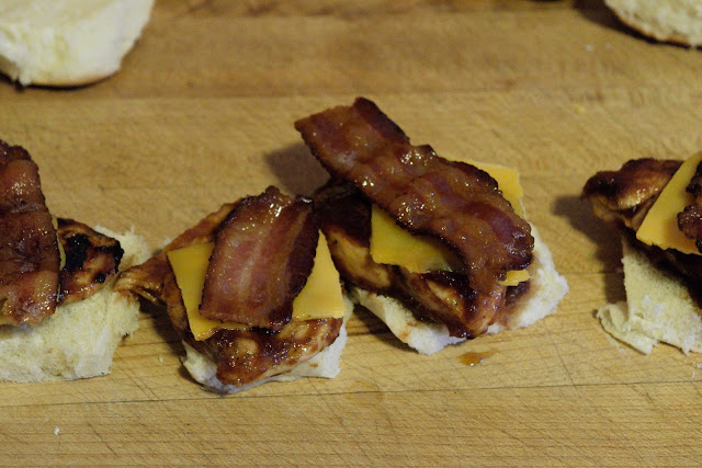 bacon being added to the bbq chicken sliders.