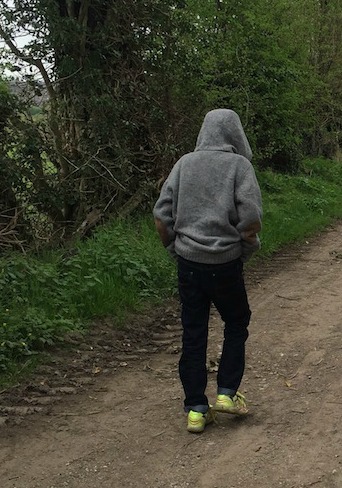 Morgan's Milieu | First Steps to Independence: Photo of a tween walking with hoodie on.