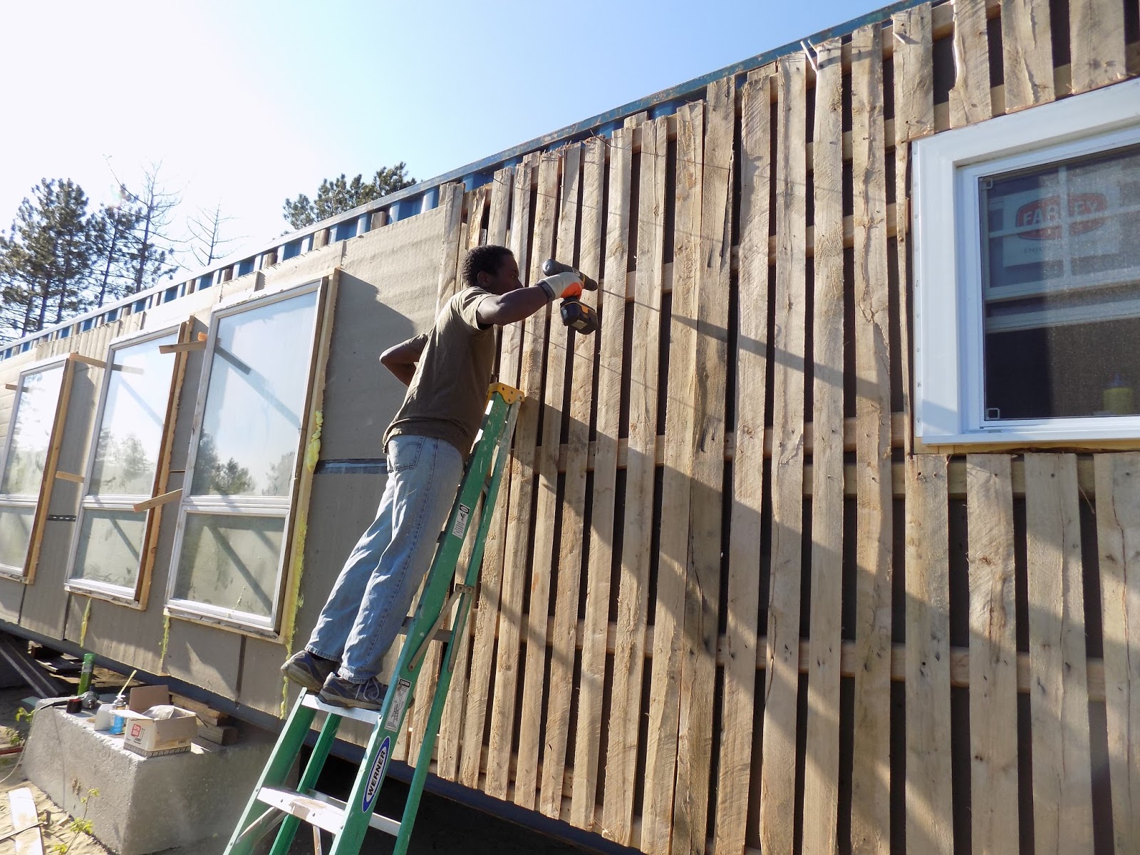 Intermodal House Strapping on, Windows in, Insulation, Siding Mostly on