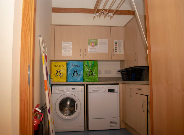 Utility room comprising of washing machine, dyer, recycling bags and cabinets