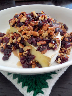 Cranberry Pecan Baked Brie:  A delicious, colorful, and simple holiday appetizer of brie topped with dried cranberries, pecans, and honey.