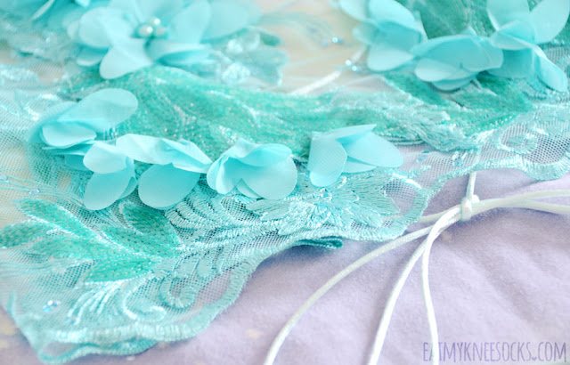 Charlotte Martin LDN Review: Mia 3D Lace Halter Crop Top Details on the handmade teal Mia 3D lace halter crop top by Charlotte Martin LDN, featuring sequined embroidery, floral applique, a lattice-style backless design, and sheer mesh bodice.