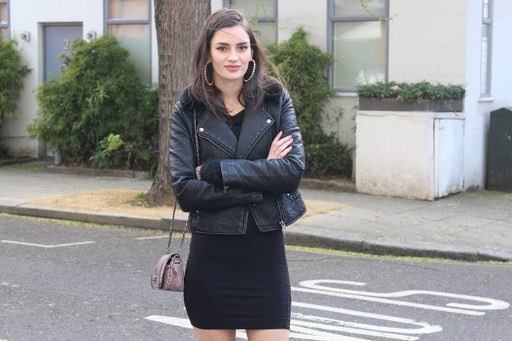 peexo fashion blogger wearing leather jacket and little black dress and snake print bag
