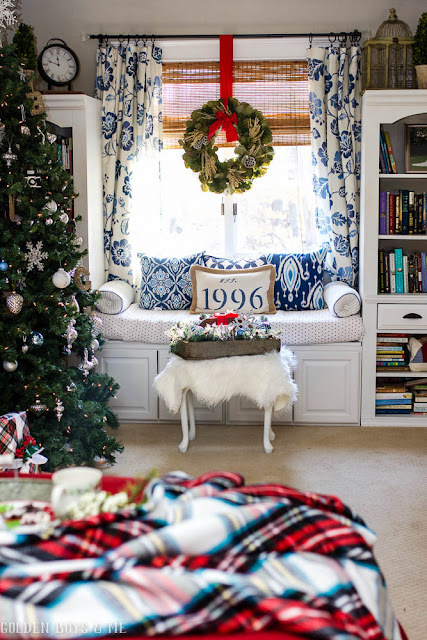 Blue and white master bedroom window seat with Christmas wreath and tree