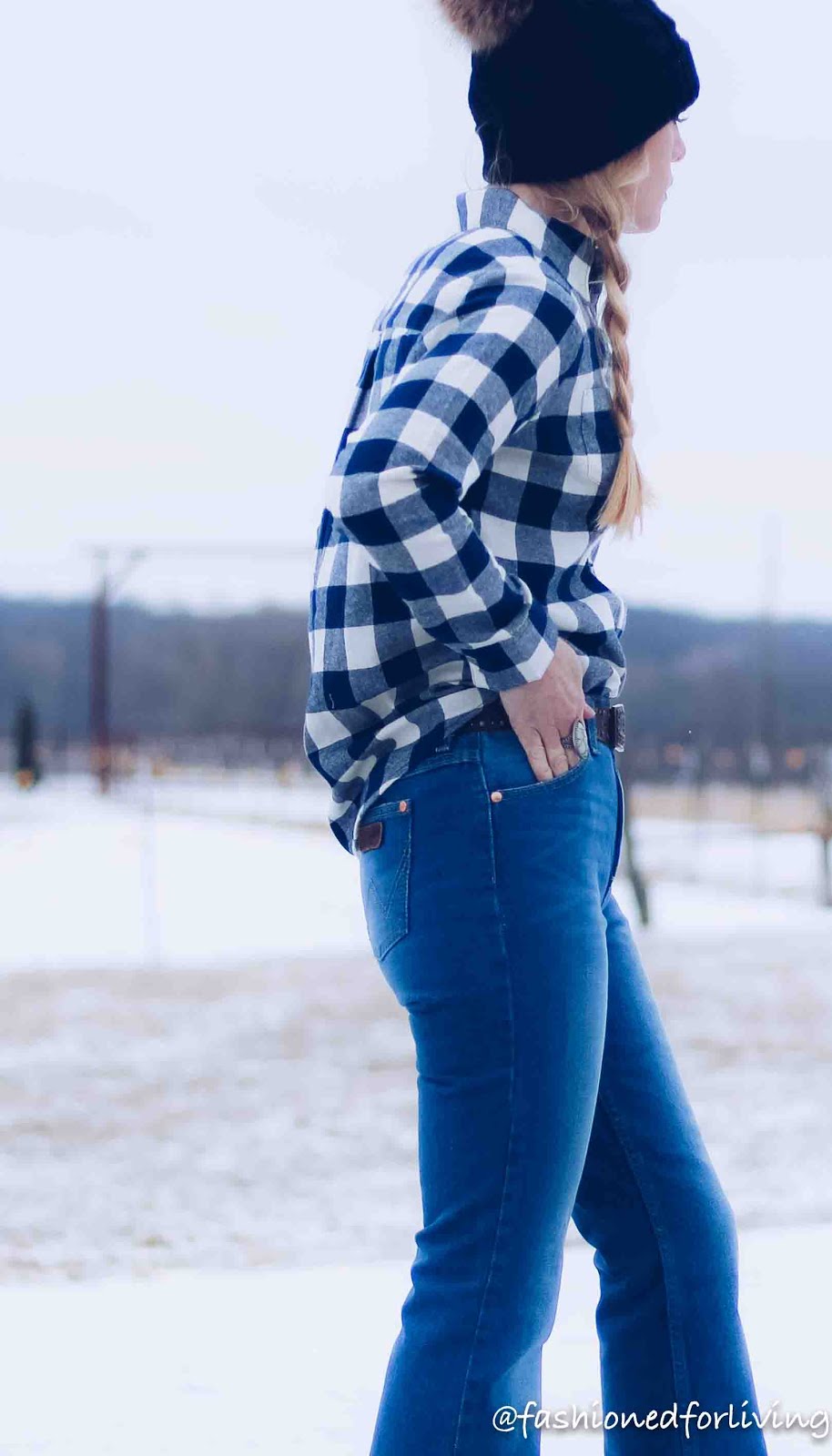 womens winter flannel outfit with knit pom hat and flare jeans