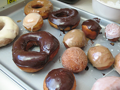 A photo of a pan of an assortment of homemade doughnuts.