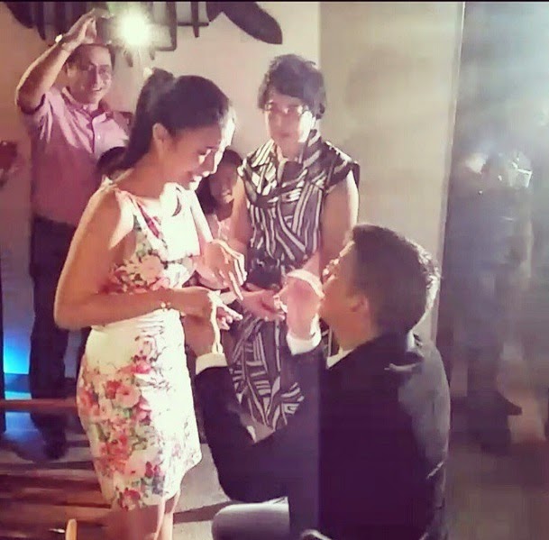 Escudero down on one knee, handing Evangelista an engagement ring