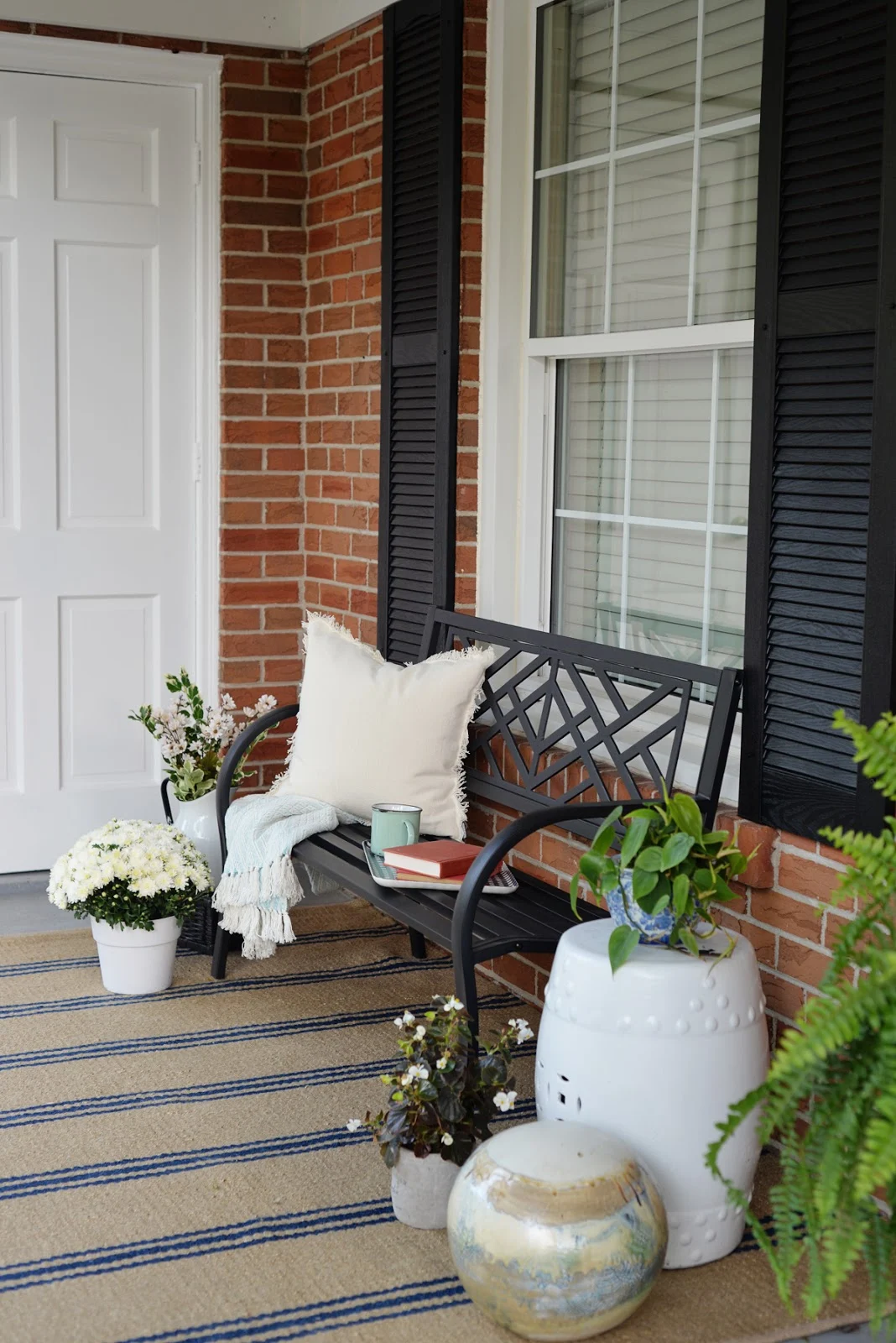 front porch decorating ideas for summer, fresh traditional front porch decor with sitting bench and striped Annie Selke rug