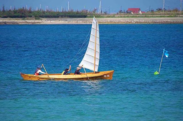 sailing sabani boat with crew of three paddlers