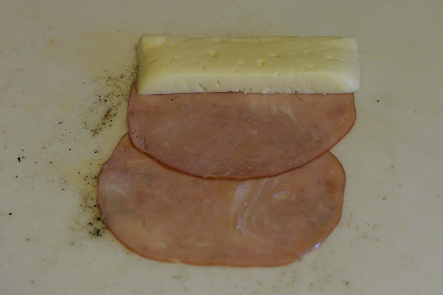 The slice of Havarti cheese place at the top of the ham slices. 