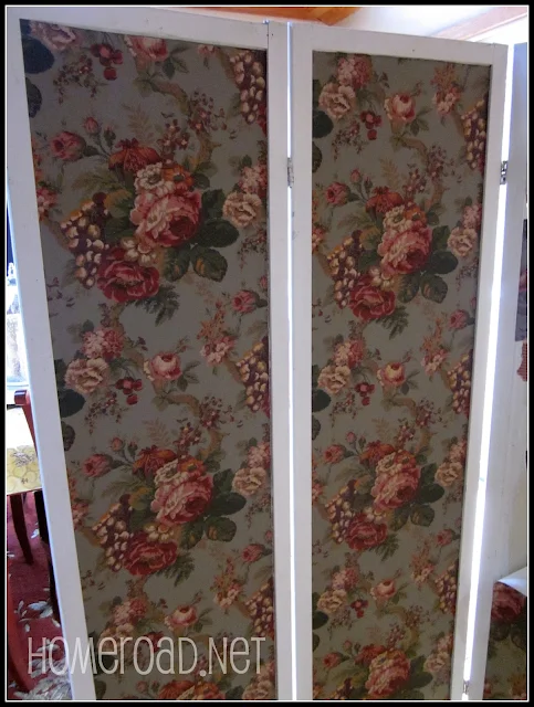 Green cabbage rose wallpaper on a room divider