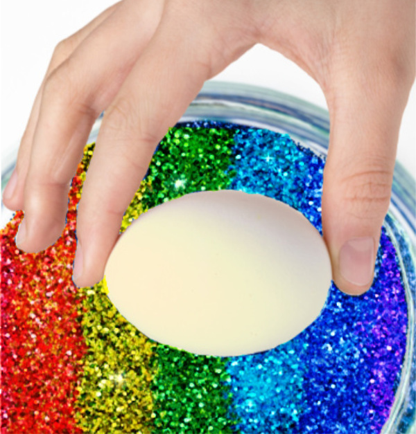 Decorate the most sparkly rainbow Easter eggs using glitter!  This decorating idea is really easy, making it great for kids of all ages! #glittereastereggs #glittereastereggsdiy #glittereggs #glittereggseaster #rainboweastereggs #rainboweggs #rainbowglitter #eggdecorating #eggdecoratingforkids #growingajeweledrose