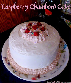 Raspberry Chambord Cake, a beautiful black raspberry infused white cake with cream cheese filling and a whipped cream frosting. | Recipe developed by www.BakingInaTornado.com | #recipe #cake