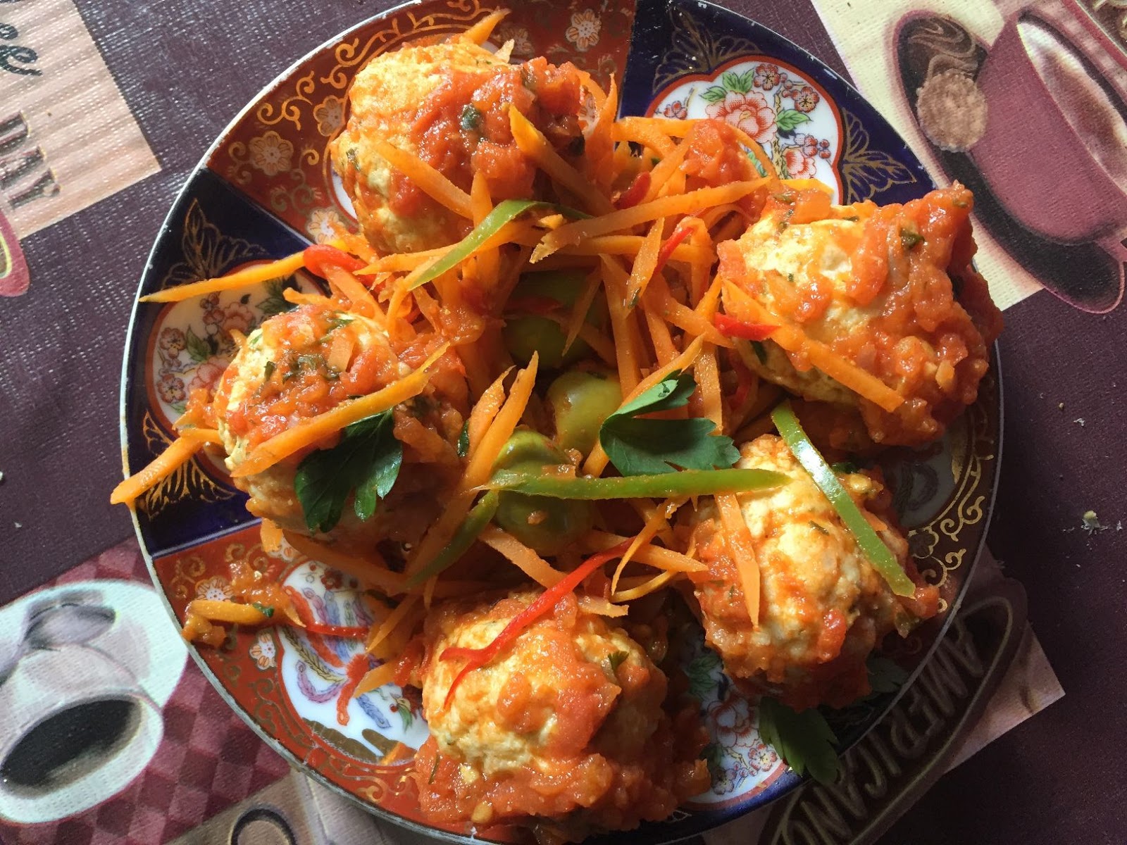 Whiting fish ball with thick tomato sauce and slightly sweated vegetables