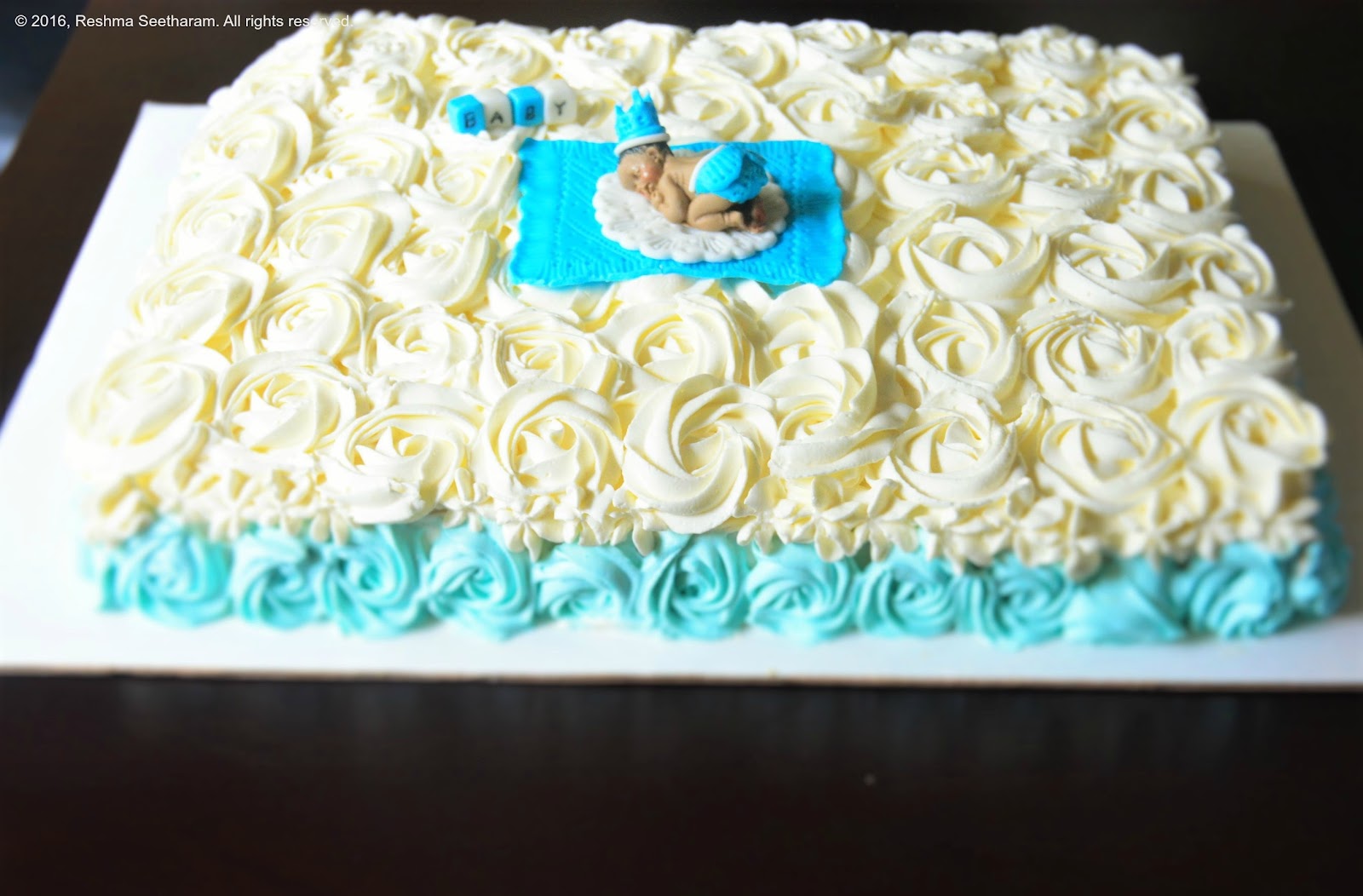 Baby shower cake whipped cream with baby boy fondant topper