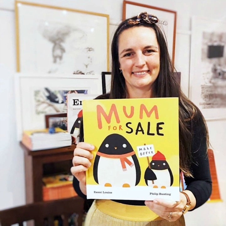 Author Zanni Louise holding a copy of her new childrens book Mum for Sale featuring popular character Errol