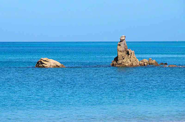 Rocks jutting out of sea close to shore