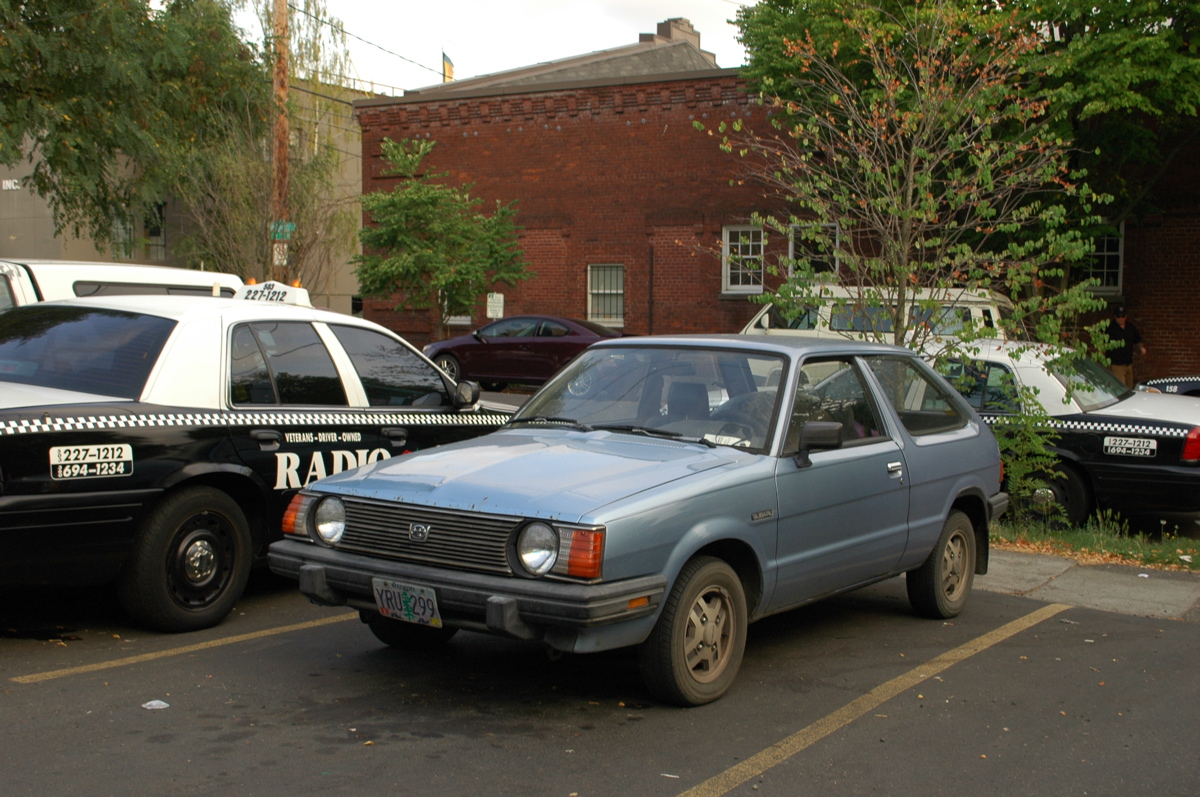 OLD PARKED CARS.: 1985 Subaru STD hatchback.