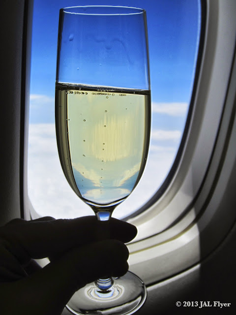 JAL JL005 FIrst Class Trip Report: Enjoying Champagne SALON at 40,000 feet in JAL First Class.