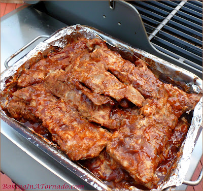 Whiskey Grilled Riblets, rubbed, slow roasted, sauced and finished on the grill. Delicious summer cookout flavors. | Recipe developed by www.BakingInATornado.com | #recipe #grilling #dinner