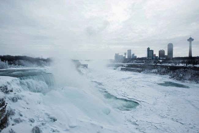 The mist coming off the falls is thick any time of year. However, in the winter, you can see the buildup as it freezes. Check out the binoculars! - Bizarrely Low Temperatures Transformed Niagara Falls Into A Frozen Wonderland