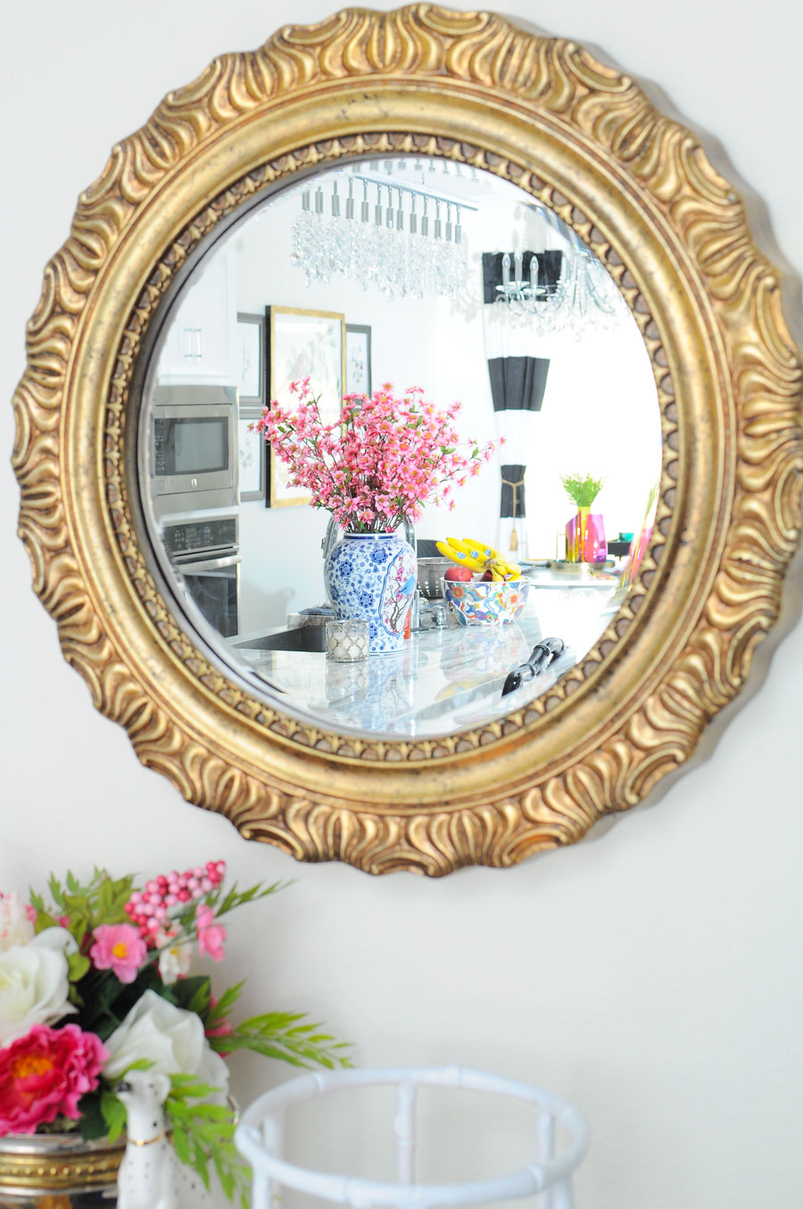 Gold mirror over a bar cart helps add light to a space. Gold mirror over a bar cart helps add light to a space.