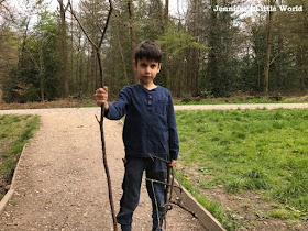 Child holding sticks in the forest