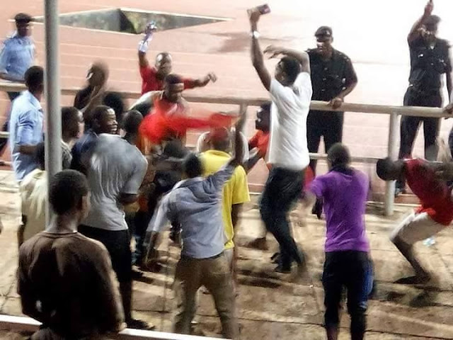 Drama as police man battles fan for openly displaying Biafran flag during football match in Enugu [PHOTOS]