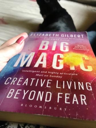 Front cover of Big Magic in hand, by Elizabeth Gilbert 