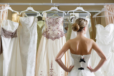 bride looking at wedding dresses